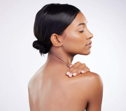 Neck Liposuction: a photo of a young woman with a dark hair after the neck liposuction.